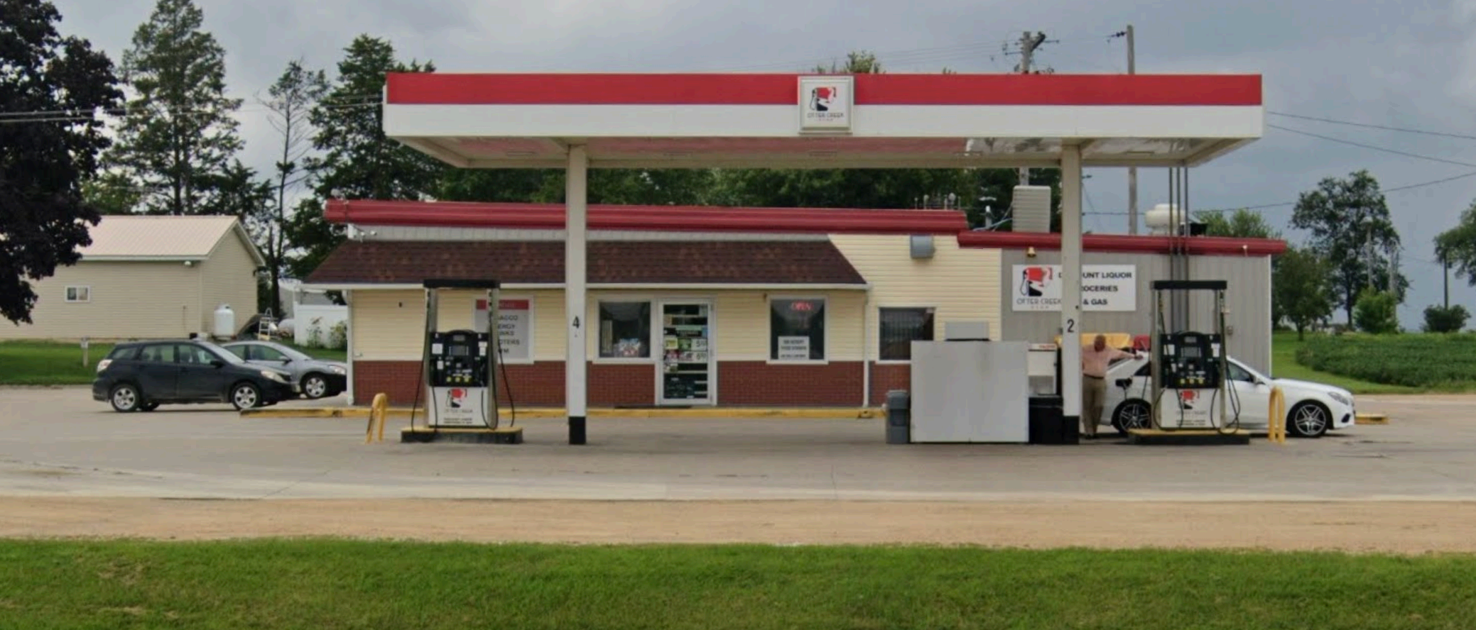 Otter Creek Stop at golden hour, a green country gas station beside Iowa cornfields